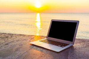 Laptop overlooking sea, representing premium choices for Dubai users
